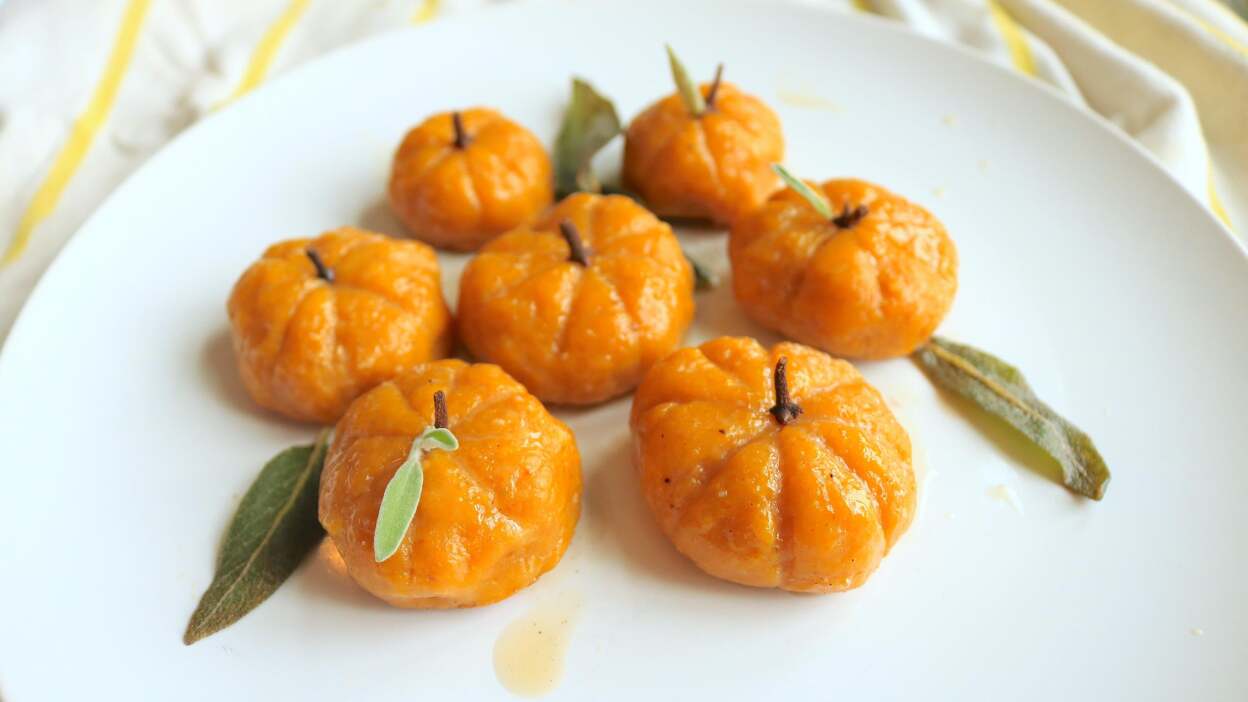 A plate of orange pumpkin-shaped gnocchi.