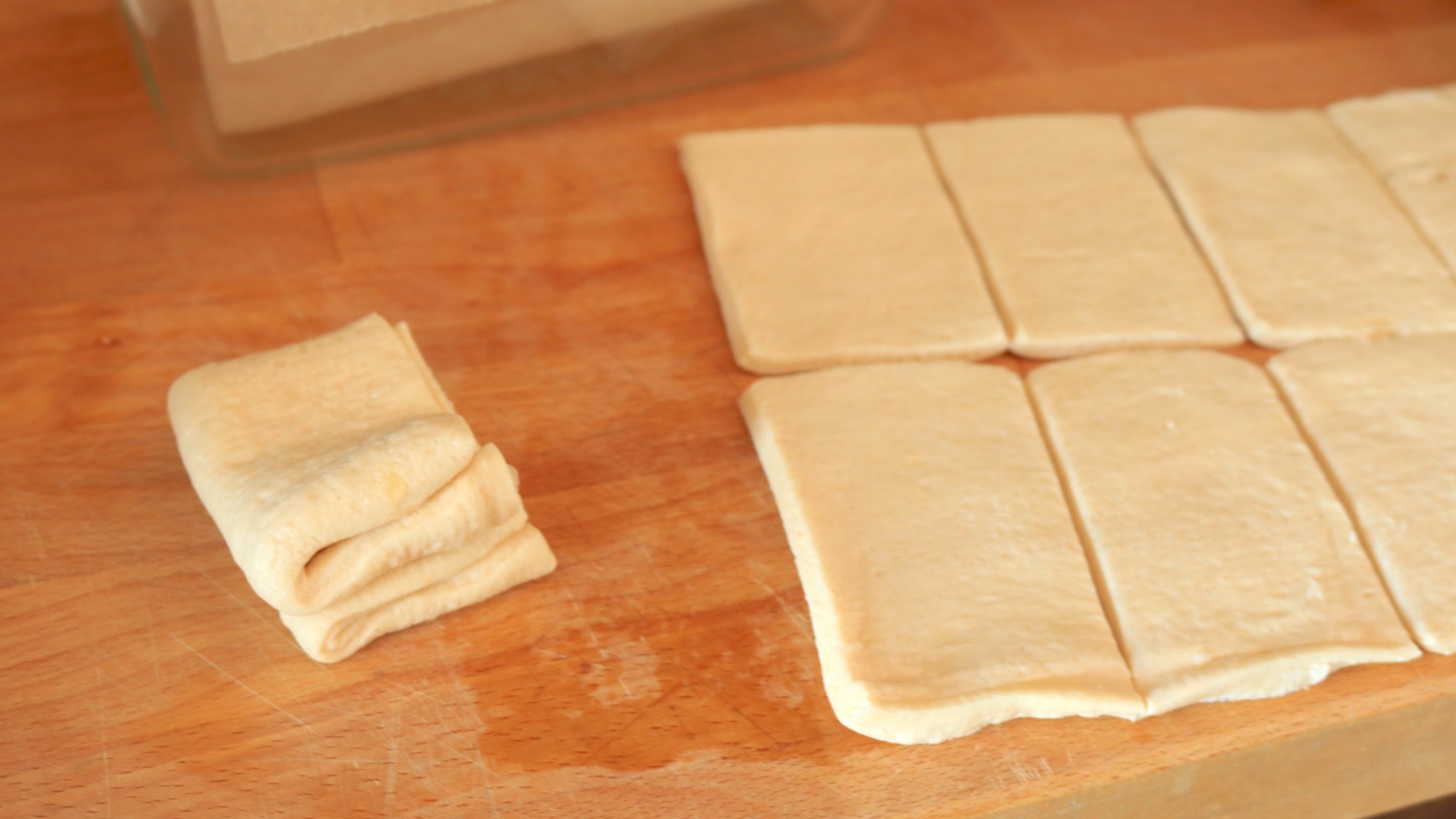 Small rectangles of dough on a cutting board.