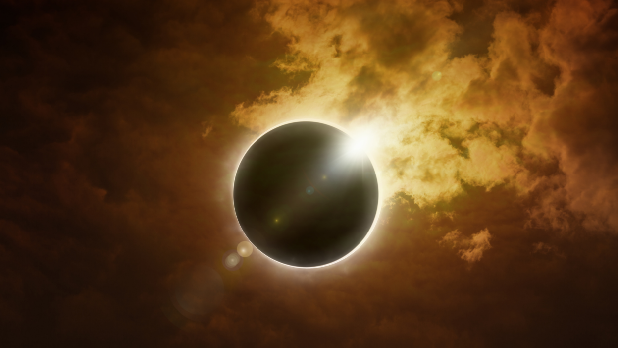 total solar eclipse in dark red glowing sky