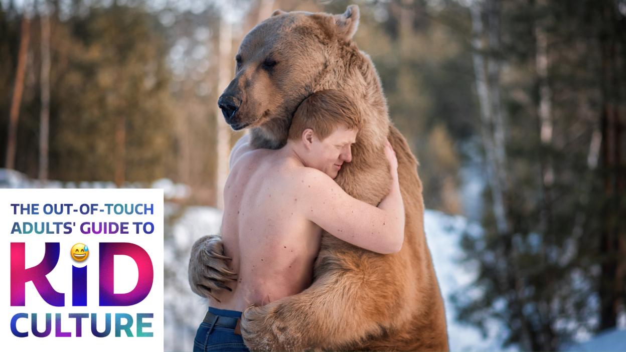 A man and a bear hugging in the forest