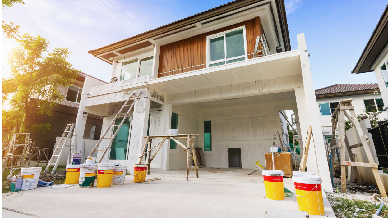 outside of house being repaired with construction equipment and ladders